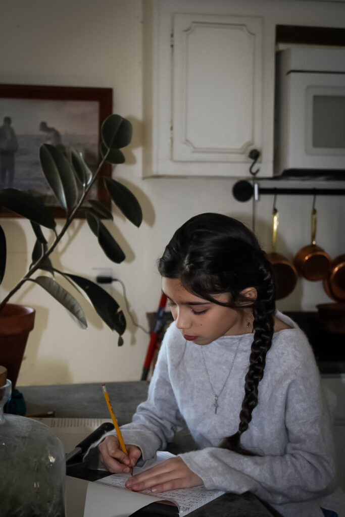 Girl doing schoolwork in a kitchen